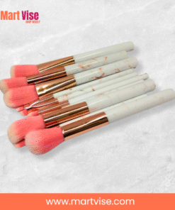 makeup-brushes-in-hand.jpg – Woman holding professional makeup brushes with rose-gold accents