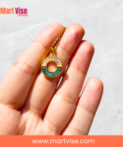 stainless-steel-golden-necklace-closeup.jpg – Close-up of abalone and crystal pendant on gold chain.