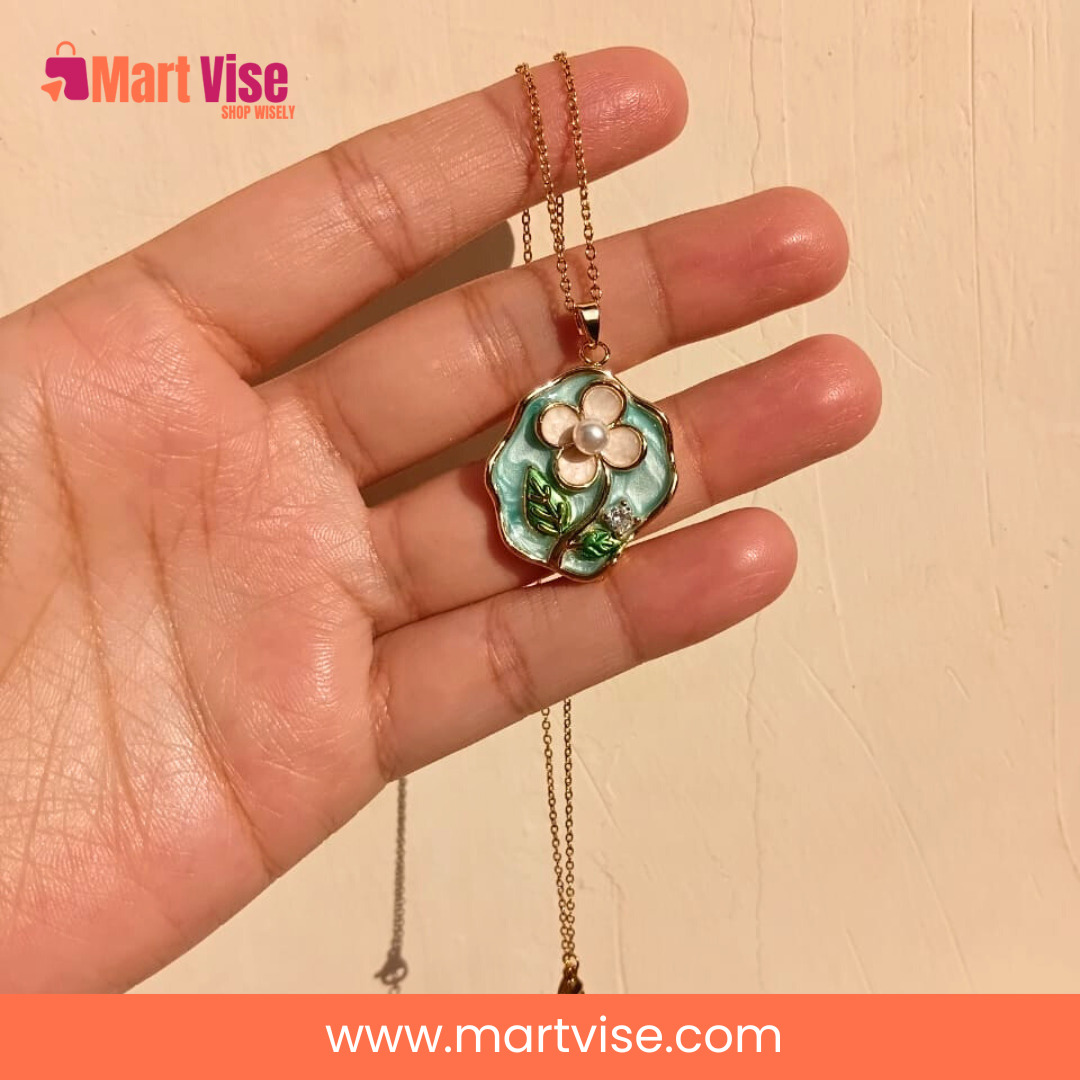 elegant-flower-necklace-closeup.jpg – Close-up of enamel flower pendant showing gold and blue details.