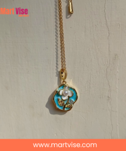 elegant-flower-necklace-closeup.jpg – Close-up of enamel flower pendant showing gold and blue details.