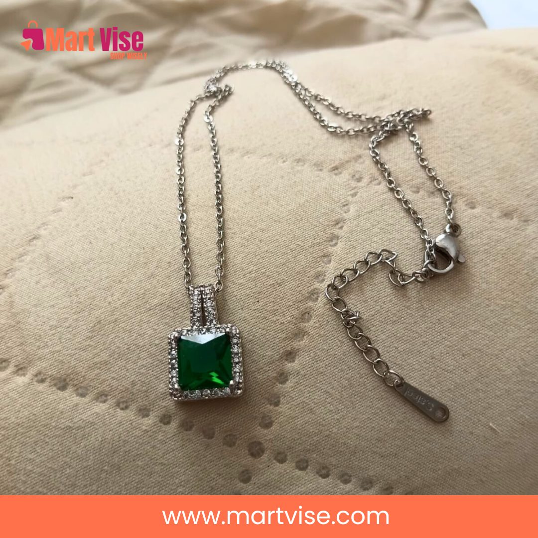 elegant-green-pendant-main.jpg – Silver-tone necklace with emerald-green square pendant and crystal border.
