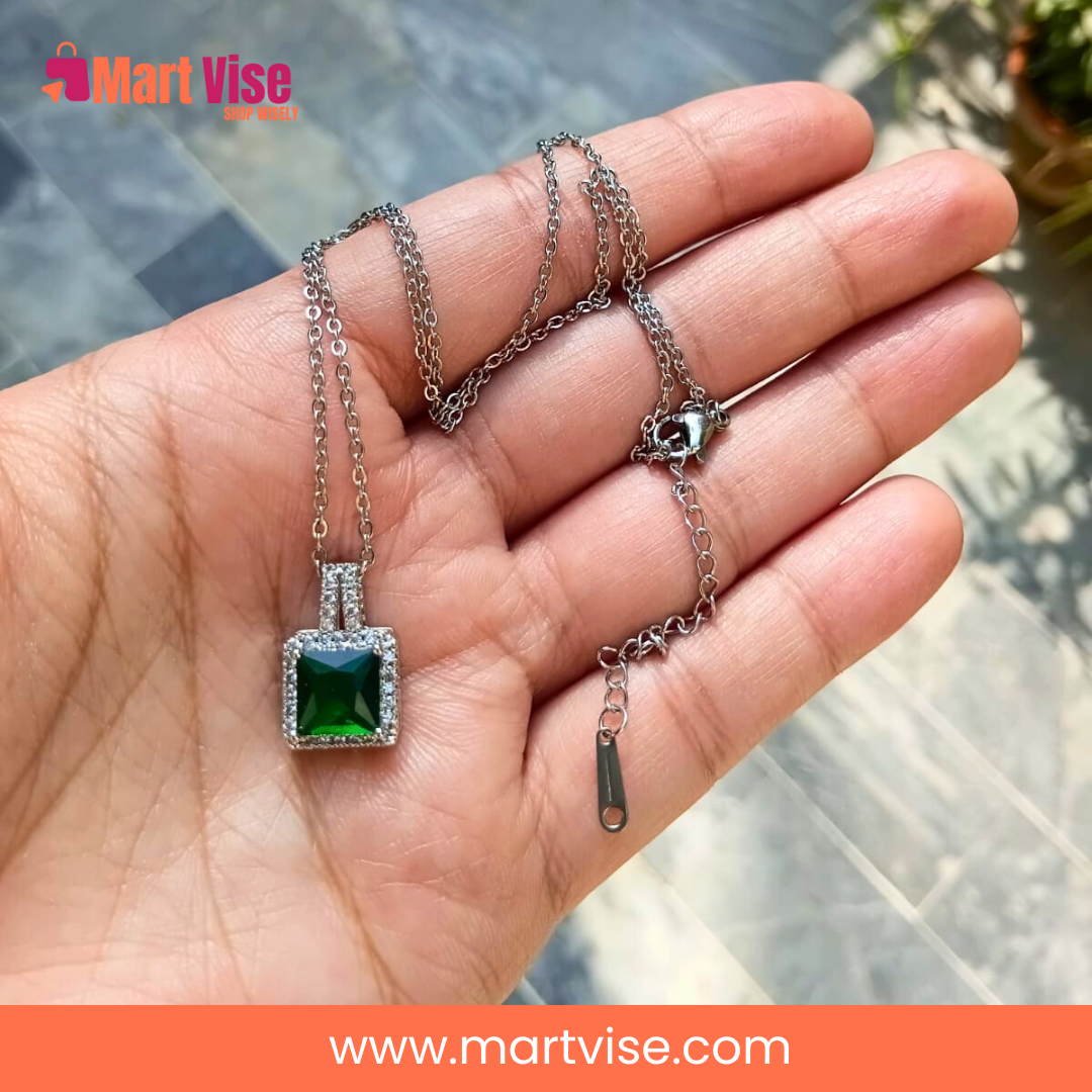 elegant-green-pendant-main.jpg – Silver-tone necklace with emerald-green square pendant and crystal border.