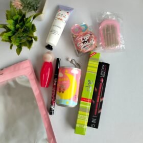 Daily Essential Kit featuring lip balm, perfume, hand cream and beauty accessories arranged together.